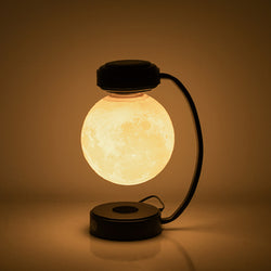 Image of 3D LED Moon Night Light Wireless Magnetic Levitating Rotatin illuminating softly in a dark setting.