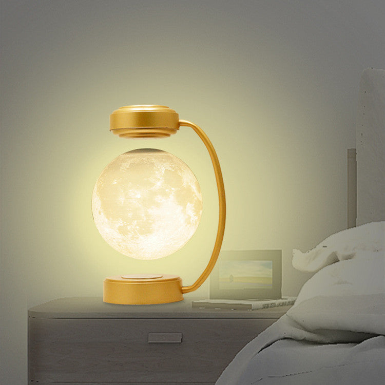 3D LED Moon Night Light Wireless Magnetic Levitating Rotatin displayed on a bedside table, illuminating a cozy bedroom.